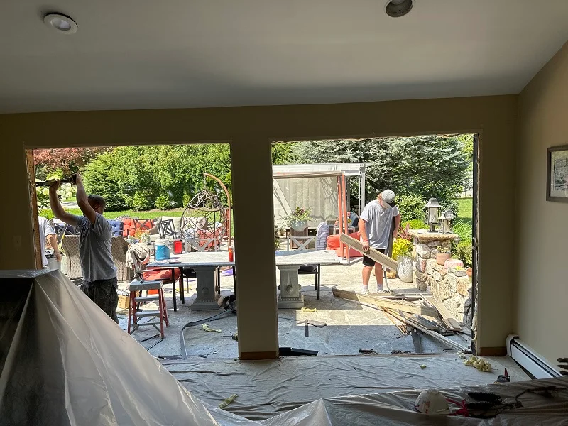 Plastic and tarps used to protect the home during patio door installation